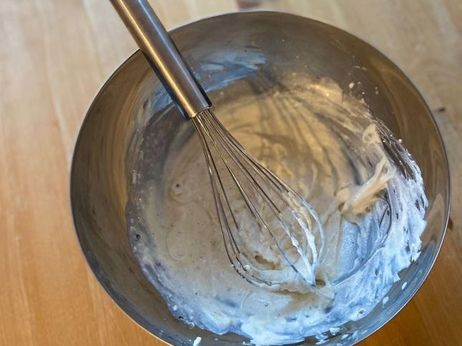 Rezept für einen Flammkuchen mit Hokkaido und Ziegenfrischkäse: Mixe dafür zuerst Ziegenfrischkäse und (pflanzliche) Milch in einer Schüssel. Schmecke die Mischung nach Belieben mit Salz, Pfeffer und Muskat ab. 